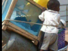 afican child on shopping cart