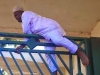 nigerian mp jumping  a fence