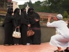 man taking pic of hijabbed women